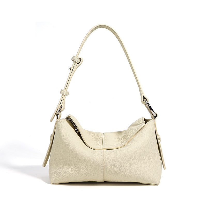 Beige handbag with a shoulder strap on a white background