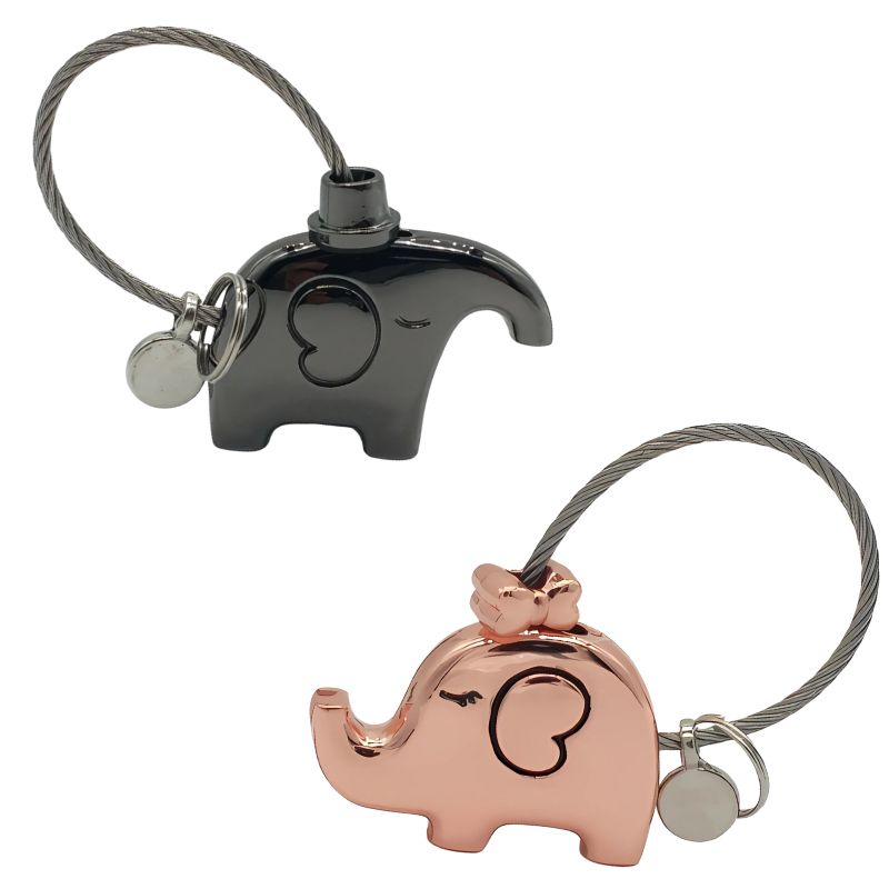 Two elephant-shaped keychains, one black and one rose gold, on a white background.