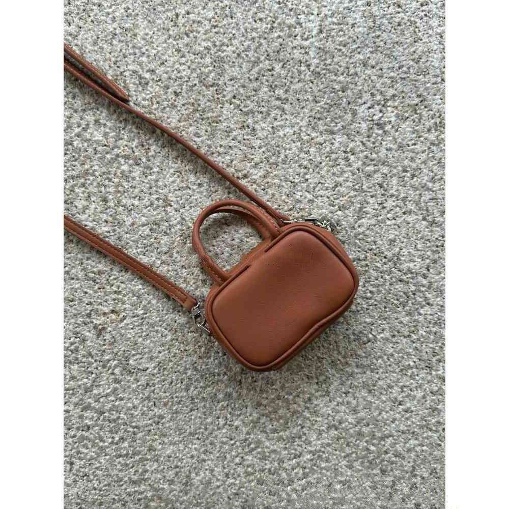 Brown crossbody bag on a textured surface