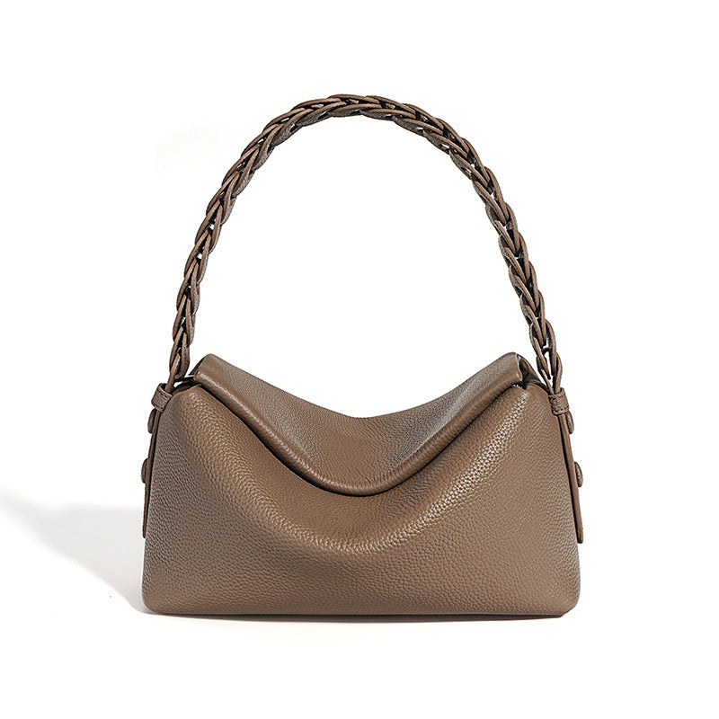 Brown handbag with braided handle on a white background