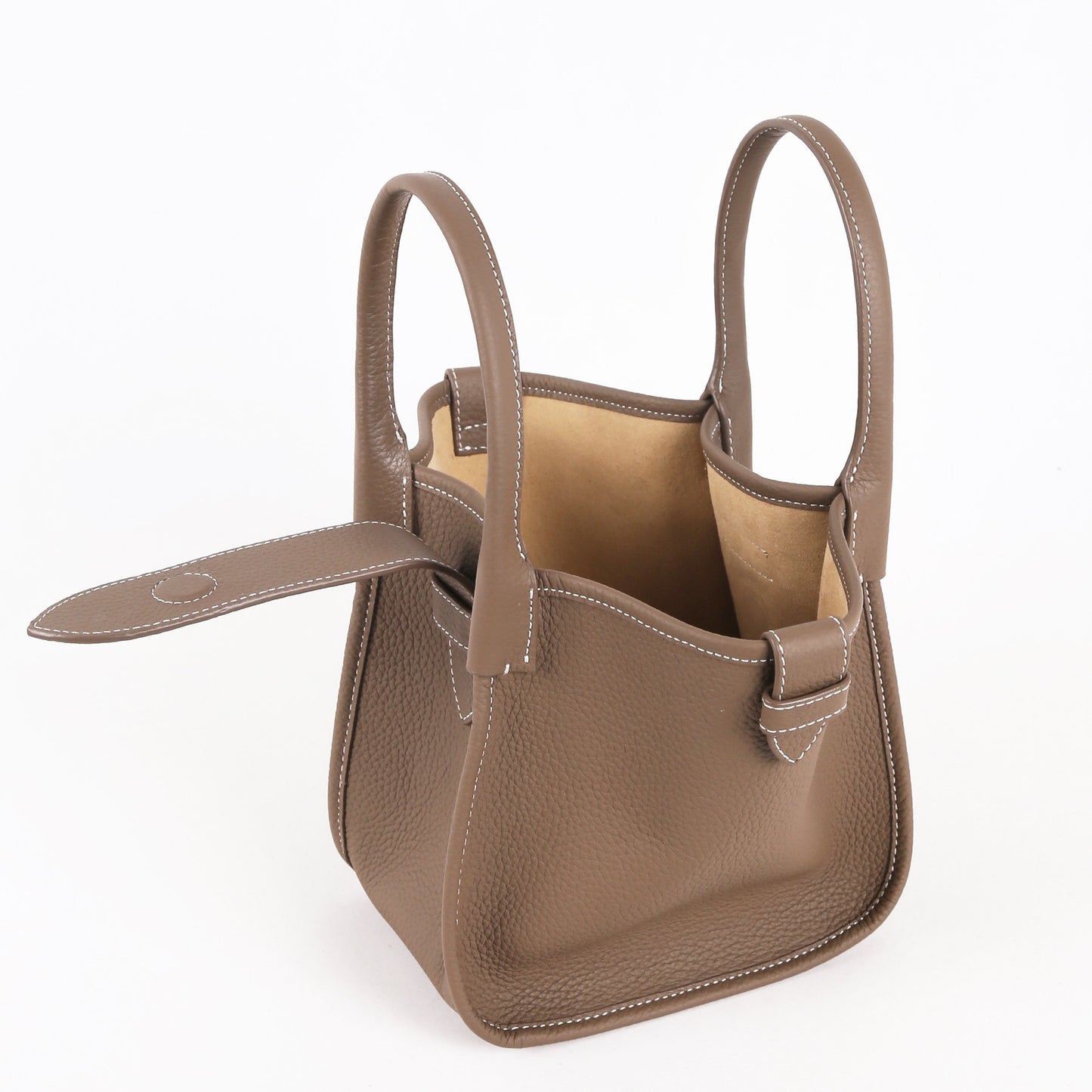 Brown leather handbag with a detachable strap on a white background