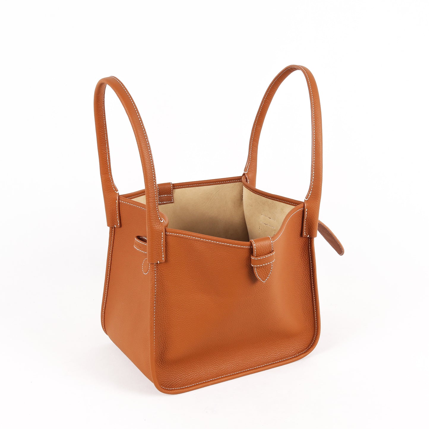Brown leather handbag with handles on a white background