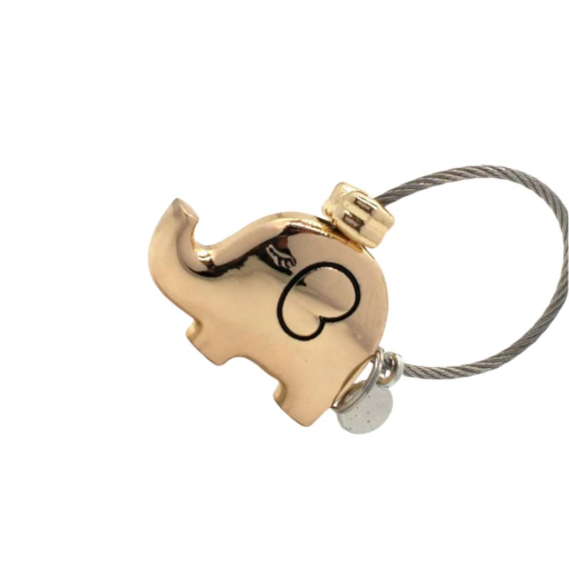 Gold elephant-shaped keychain with a heart design on a white background