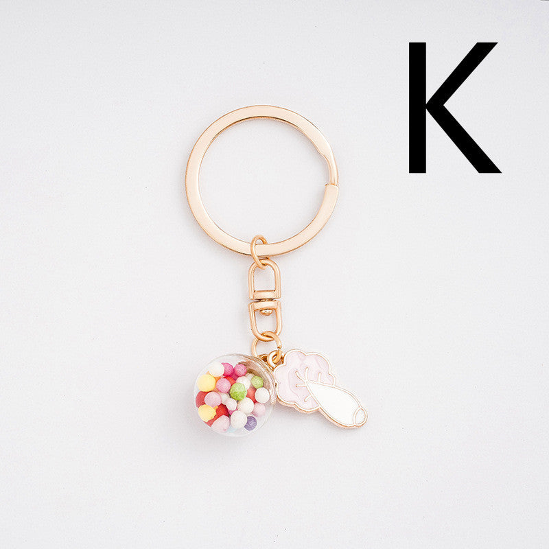 Key-shaped keychain with colorful beads on a light gray background