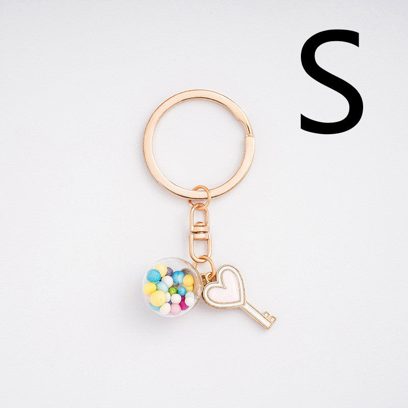 Keychain with heart-shaped key and colorful beads on a white background