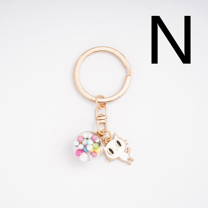 Keychain with heart and cat charm on a white background
