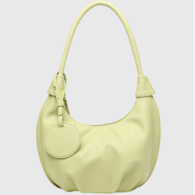 Light yellow handbag on a light gray background