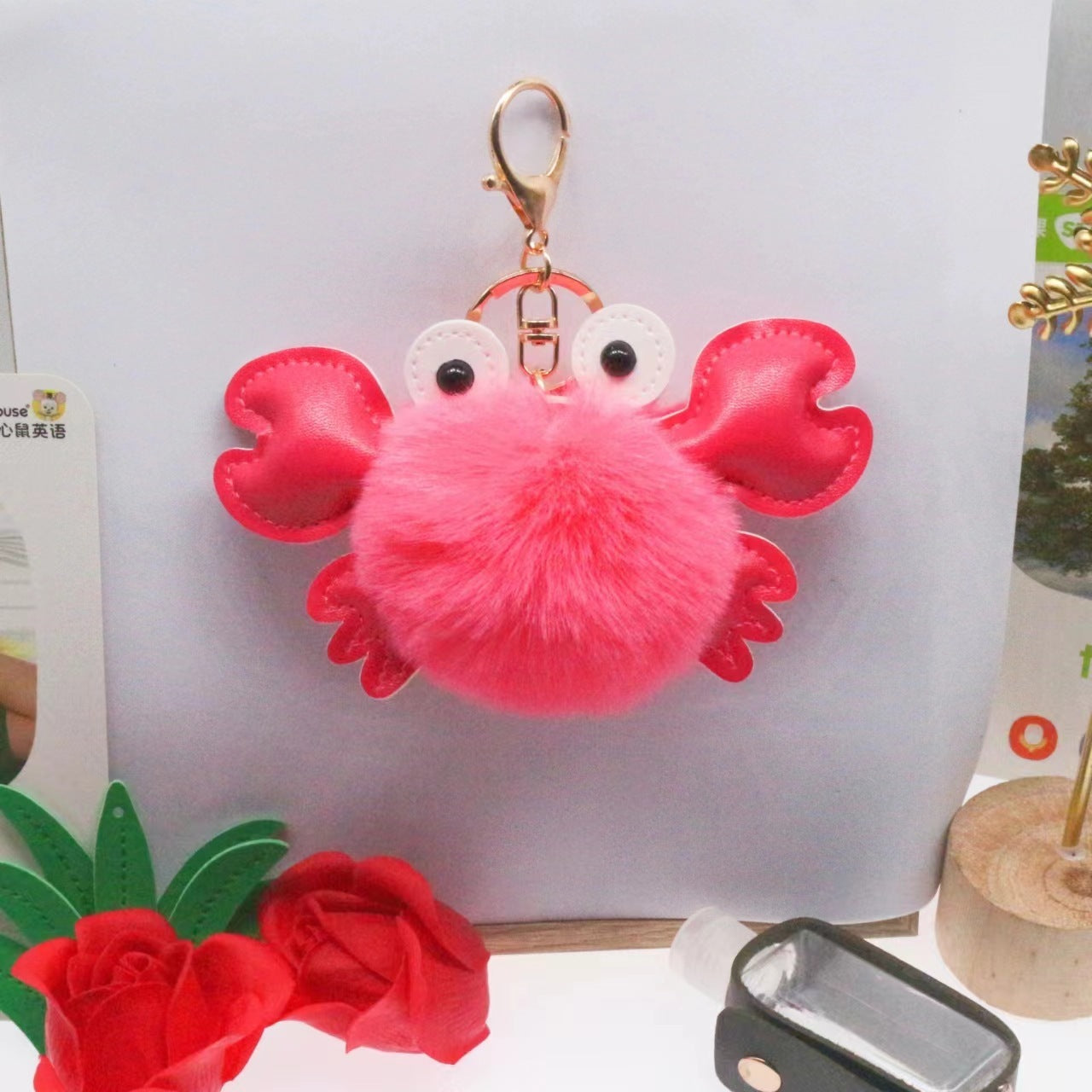 Pink crab-shaped keychain with a fluffy body