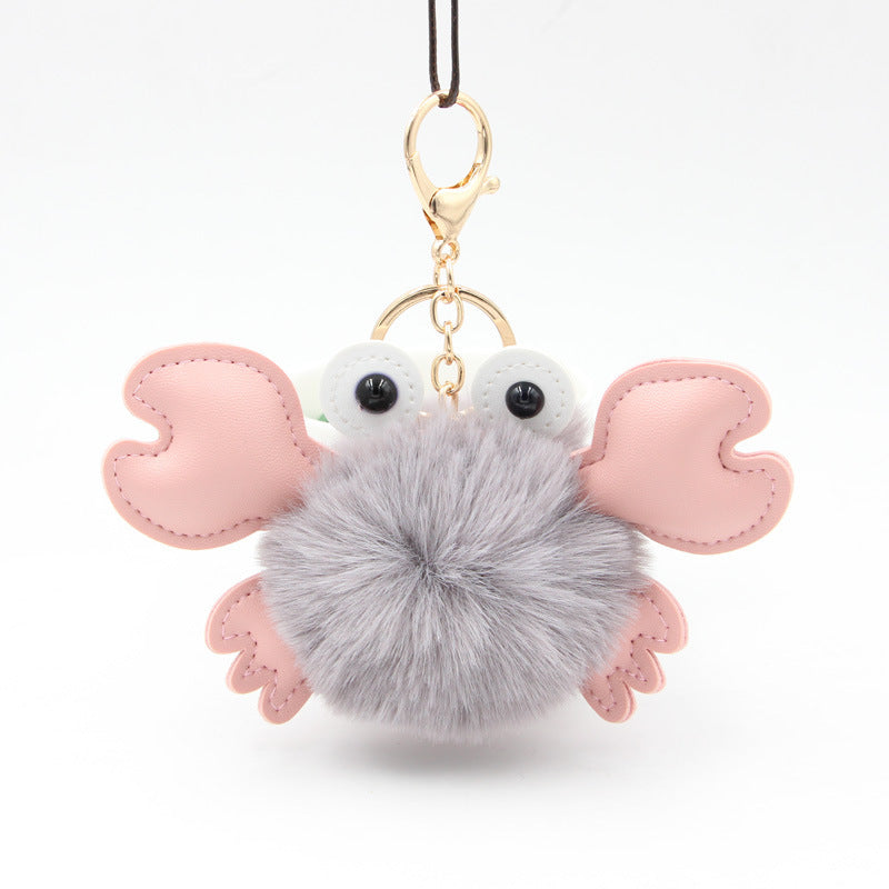 Pom-pom keychain with pink wings and a gray body