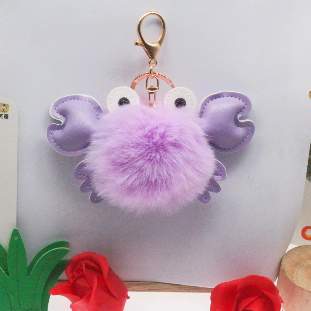 Purple crab-shaped keychain with a fluffy center