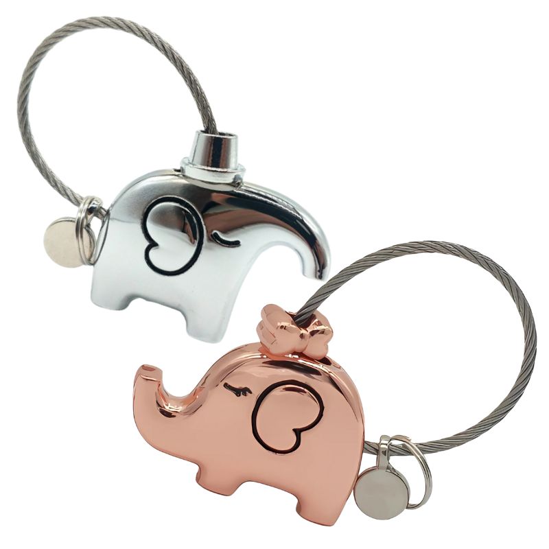 Two elephant-shaped keychains, one silver and one rose gold, on a white background.