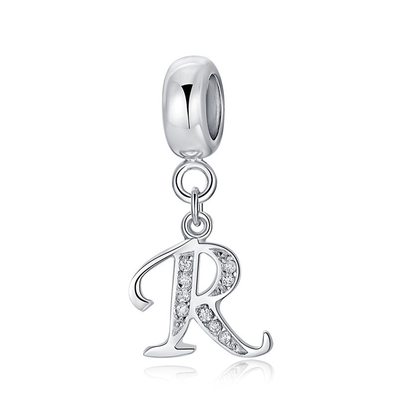 Silver charm with letter R