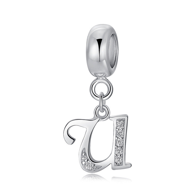 Silver charm with letter U