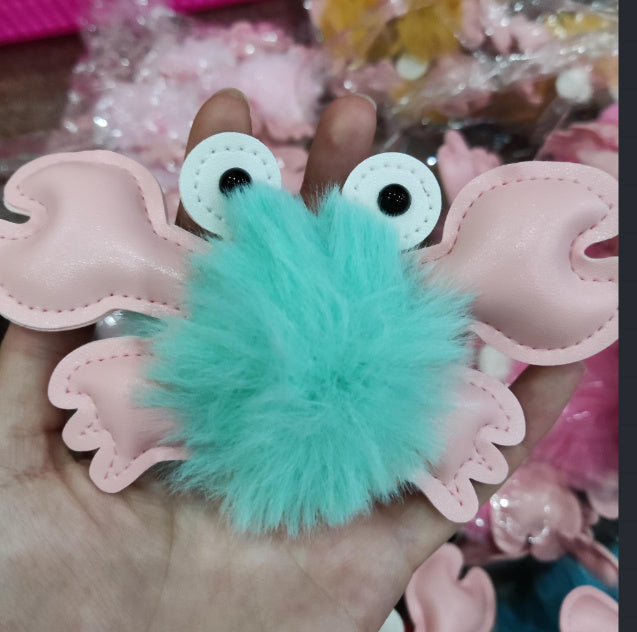 Turquoise fuzzy keychain with googly eyes