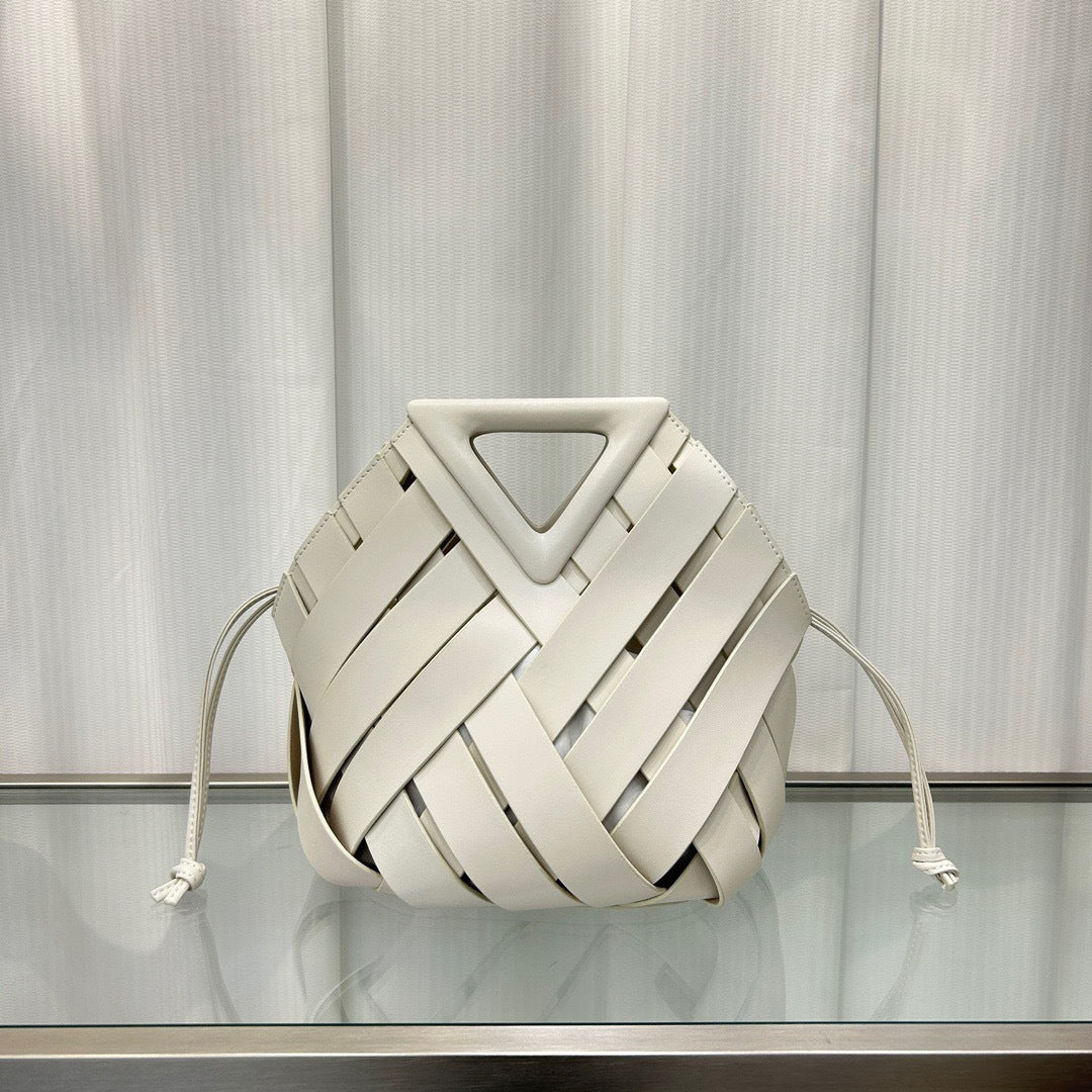 White woven bag with a geometric design on a reflective surface