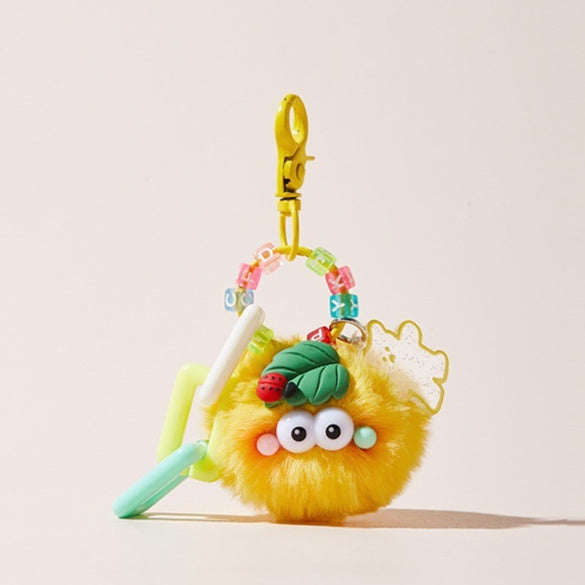 Yellow plush keychain with a spoon and colorful beads