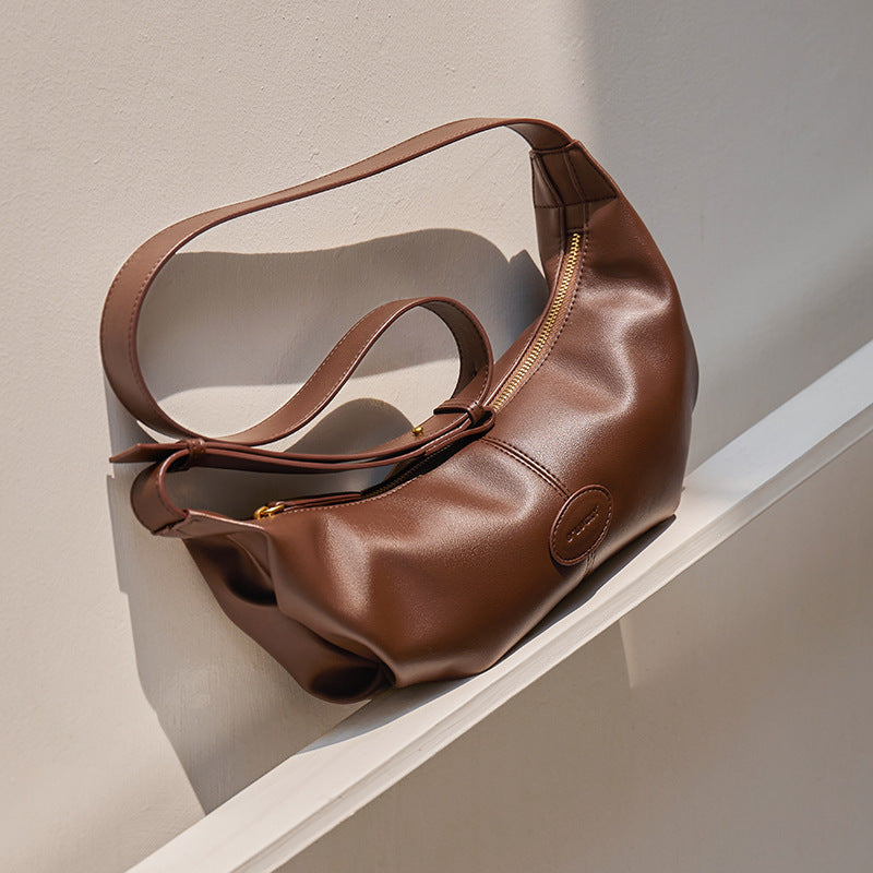 Side angle of soft dumpling cowhide crossbody bag