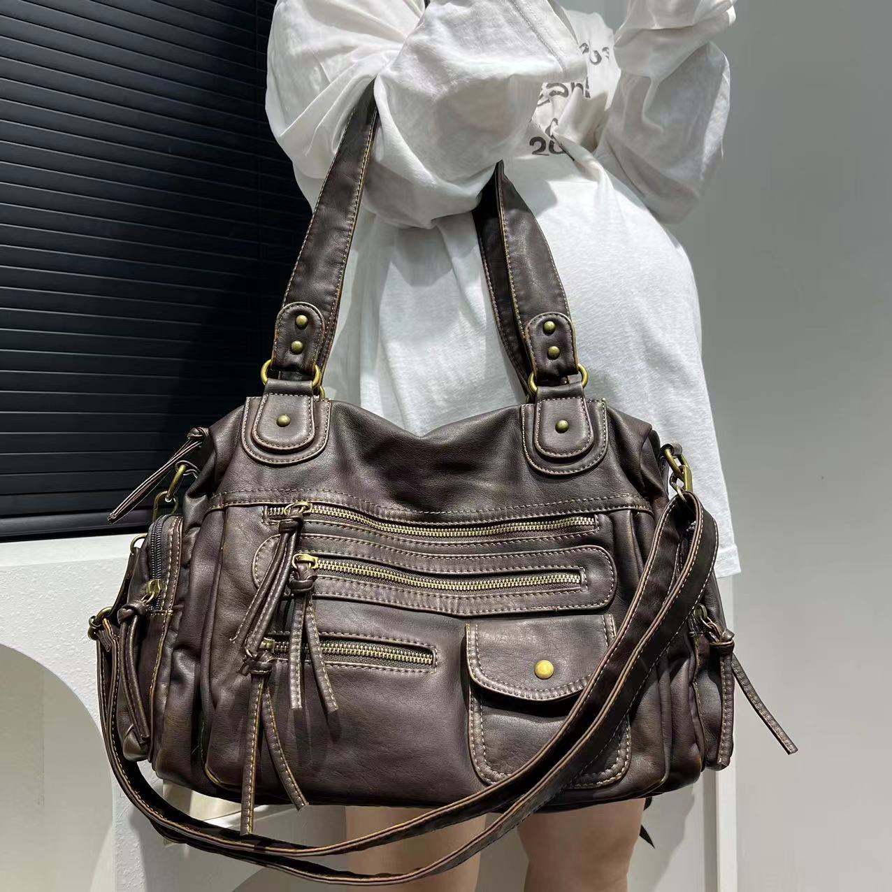 Brown distressed leather tote with zipper compartments