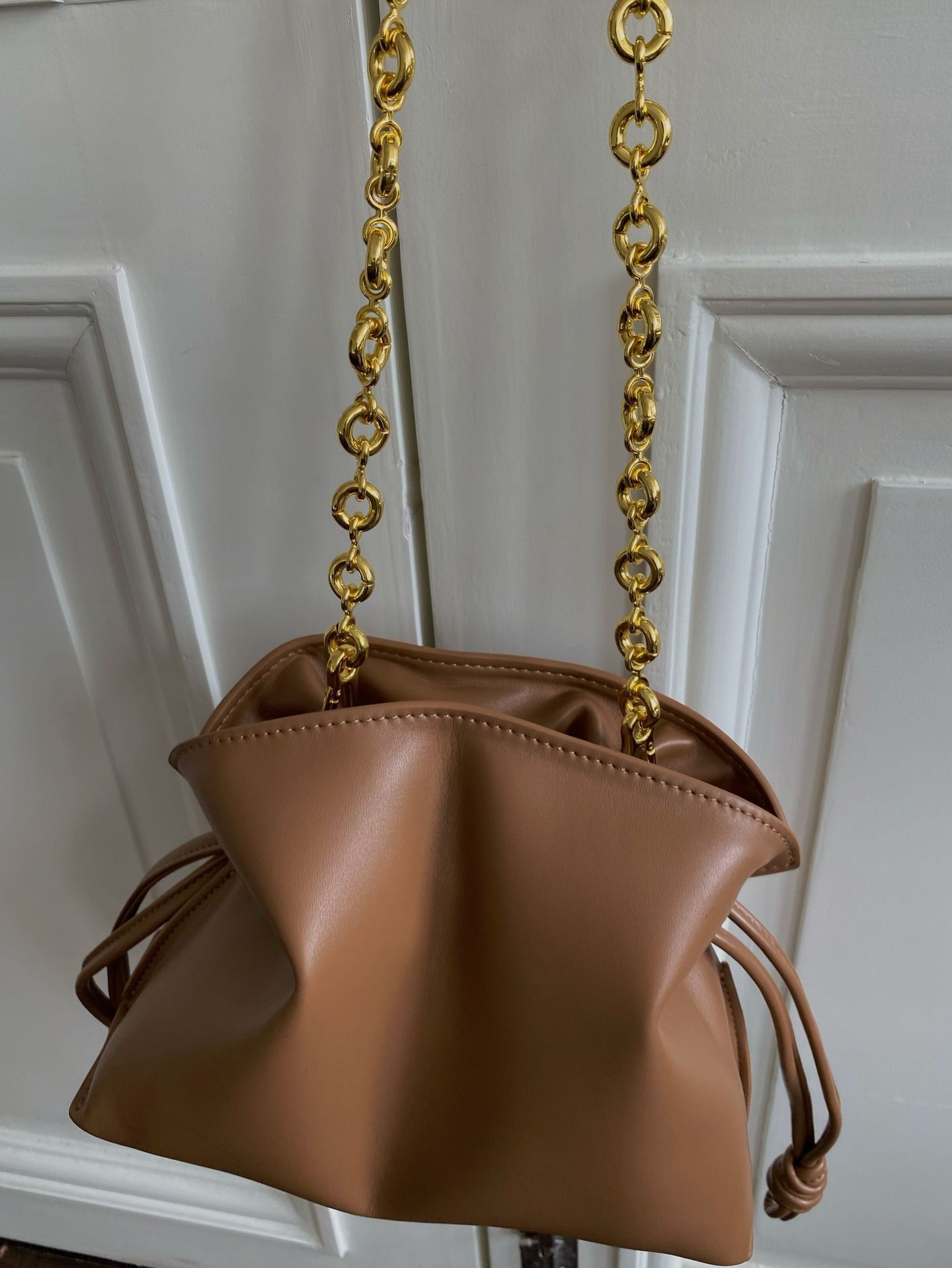 Underside view of brown women's cowhide bucket dumpling bag