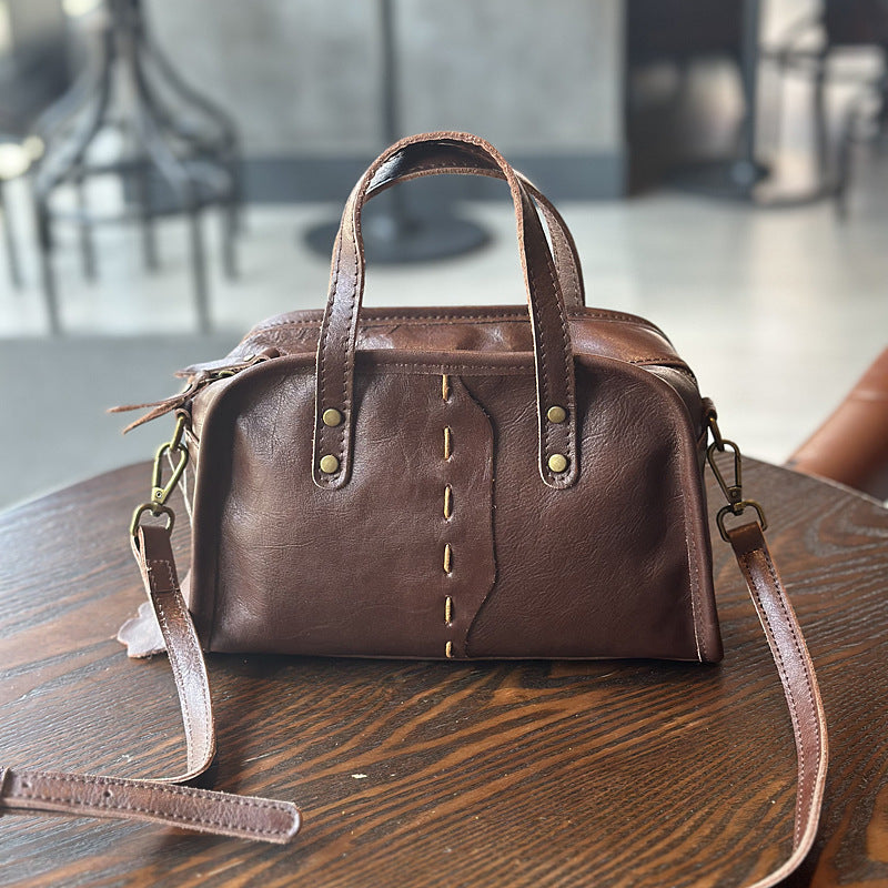 Woman wearing casual retro leather crossbody bag in brown