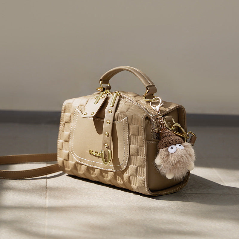 Compact autumn cowhide bag with modern simplicity