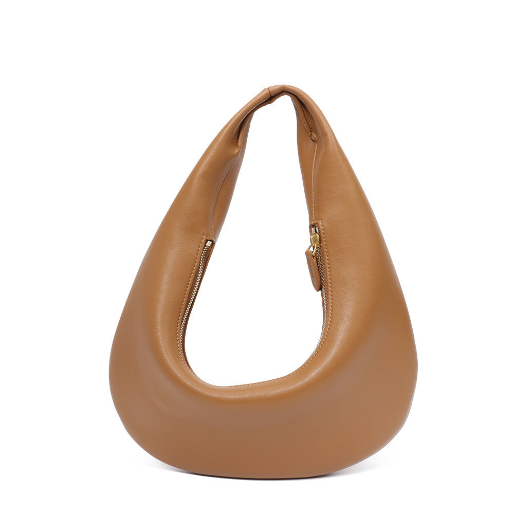 Close-up of soft cowhide texture in minimalist shoulder bag