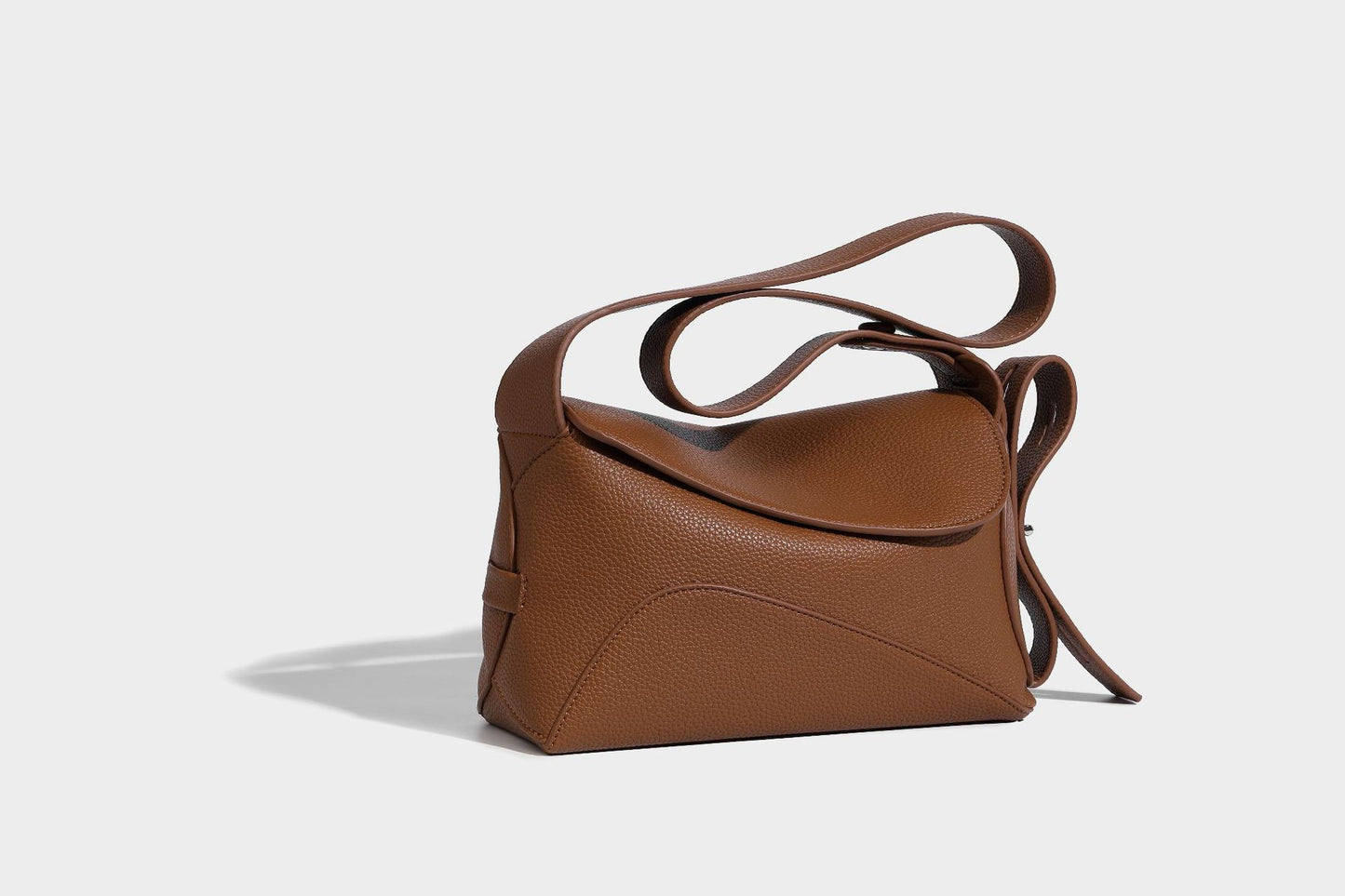 Close-up of magnetic snap and zipper on leather shoulder tote