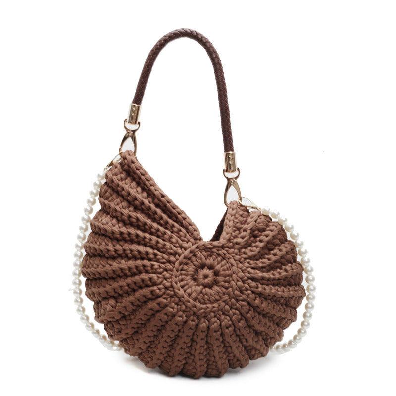 Woman wearing handmade woven shell tote with eco-friendly look