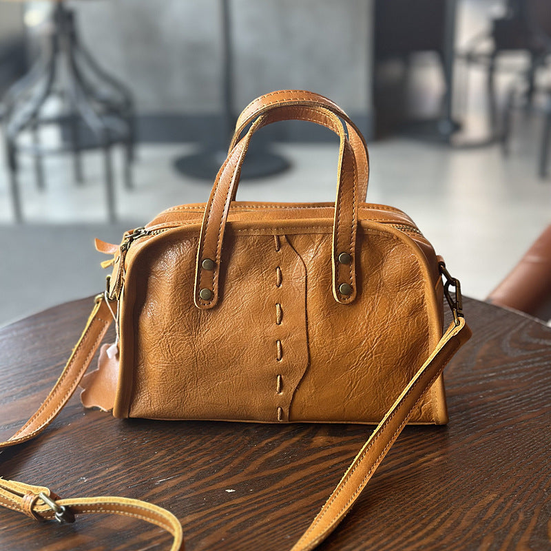 Black and brown lightweight leather handbags side by side
