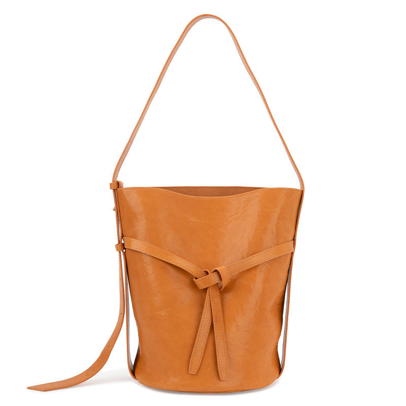 Model wearing retro genuine leather shoulder bucket bag
