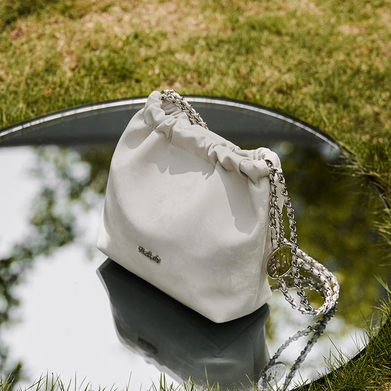 Interior pockets of leather bucket bag with phone & document slots