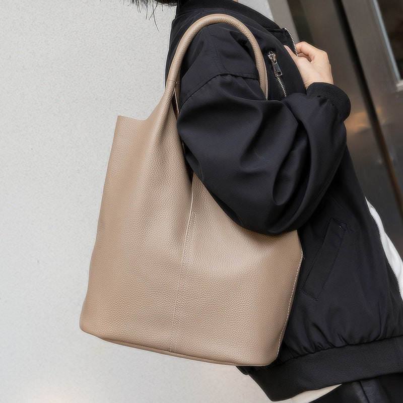 Interior view of khaki bucket-style leather tote with compartments