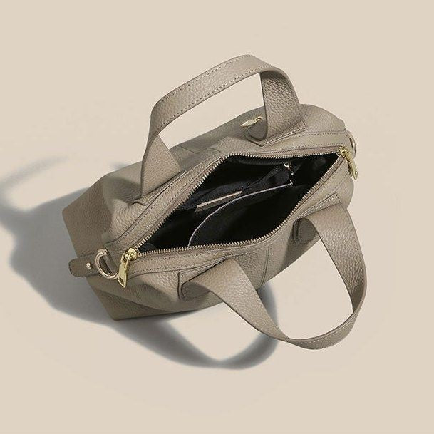 Beige square-shaped leather crossbody with organized interior