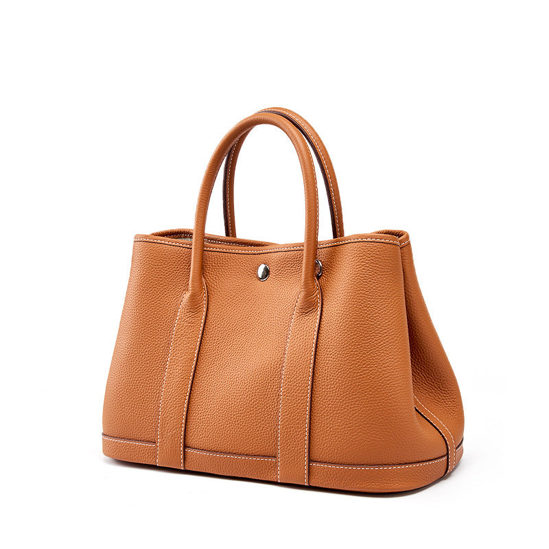 Cowhide lining and classic stitching in retro leather tote