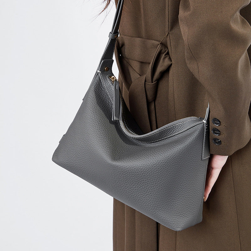 Gray leather messenger purse with structured pillow shape