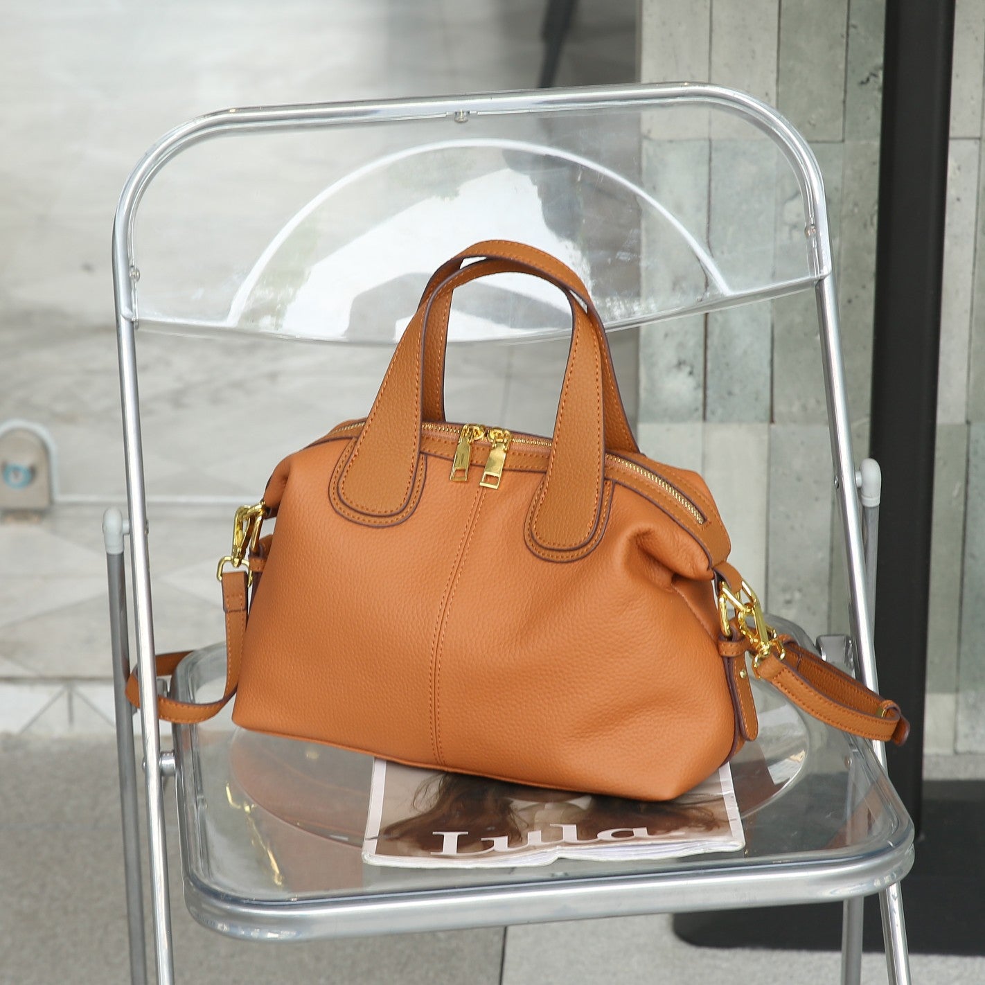 Interior of leather shoulder bag showing multiple compartments
