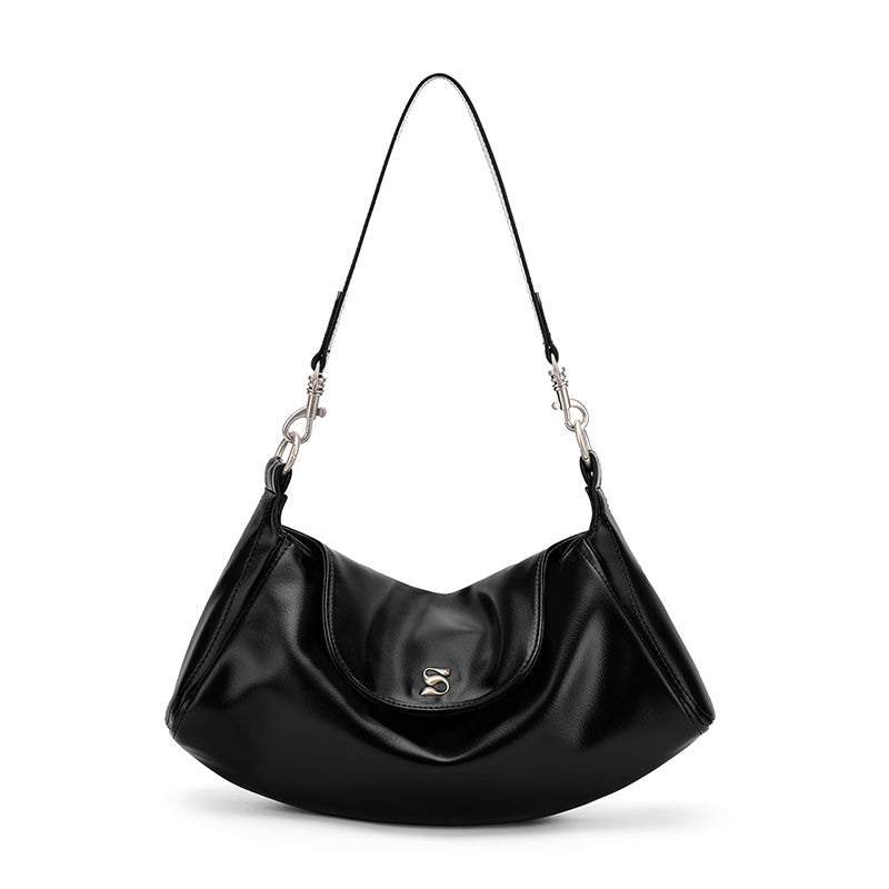 Magnetic snap closure on modern underarm shoulder bag