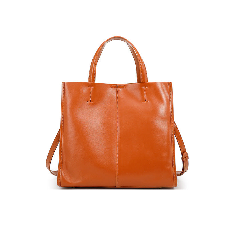 Vintage satchel tote resting on a wooden bench