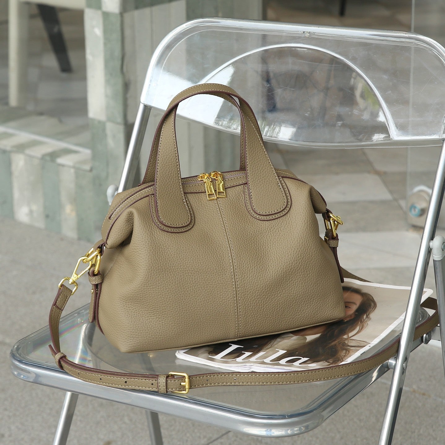 Side view of luxury cowhide crossbody bag with zipper compartments