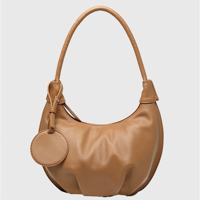 Woman styling fresh soft leather crescent dumpling bag