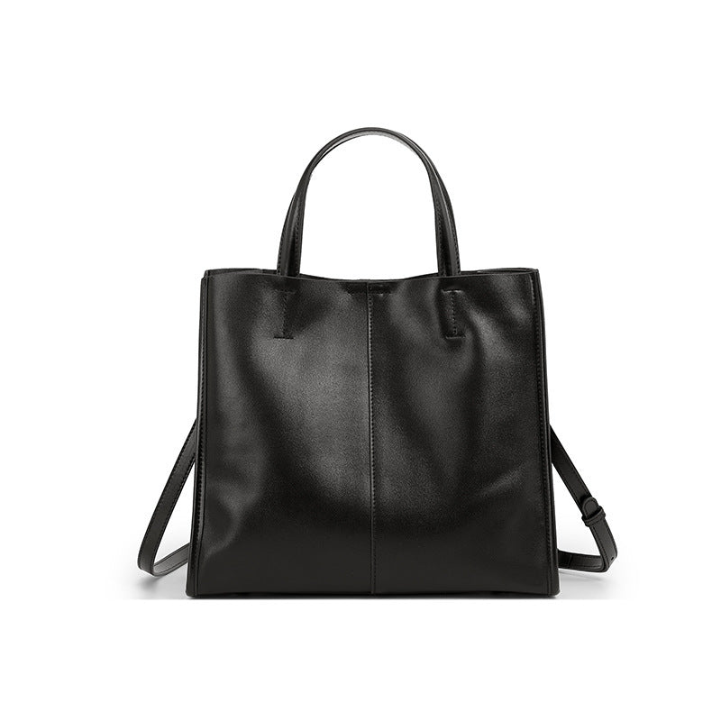 Woman carrying large capacity vintage leather satchel