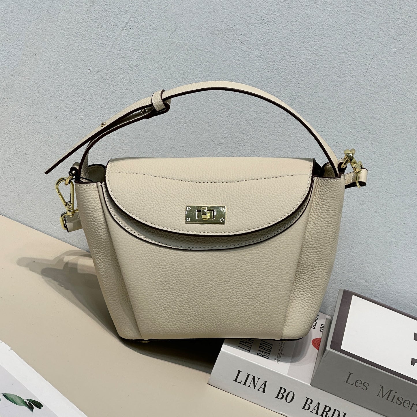 Macaron shoulder bag flatlay with accessories