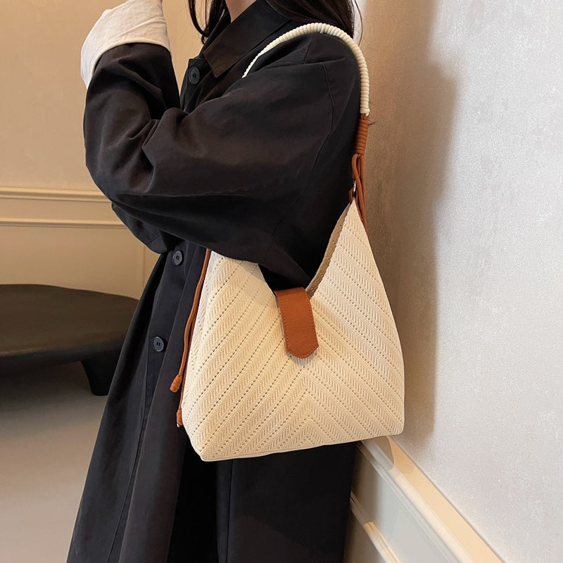 Model carrying large nylon tote bag on shoulder