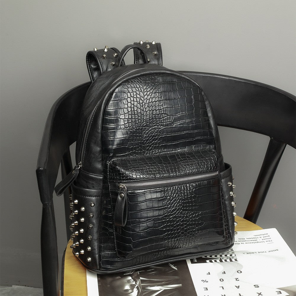 Close-up of oil wax PU leather and rivet detailing on laptop bag