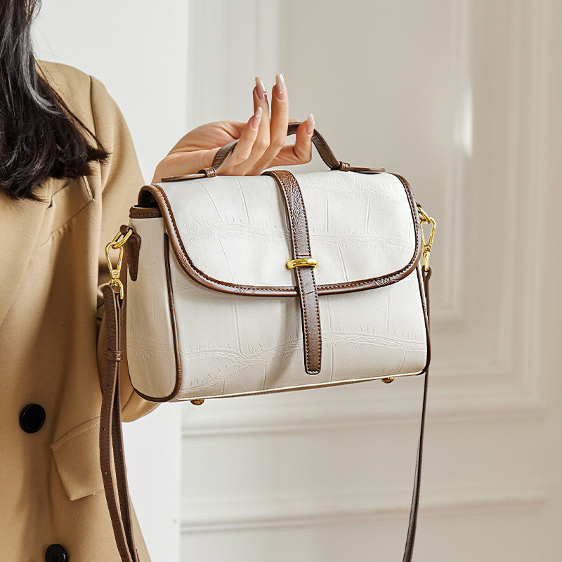 Inside mobile phone and document pockets of cowhide messenger bag
