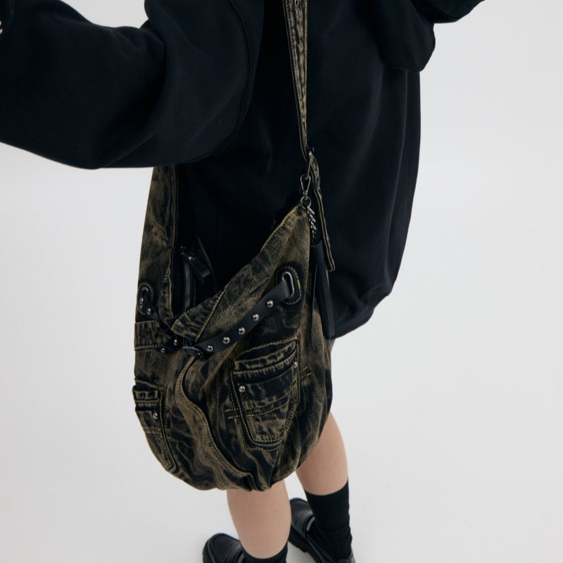 Model wearing denim punk bag with strap