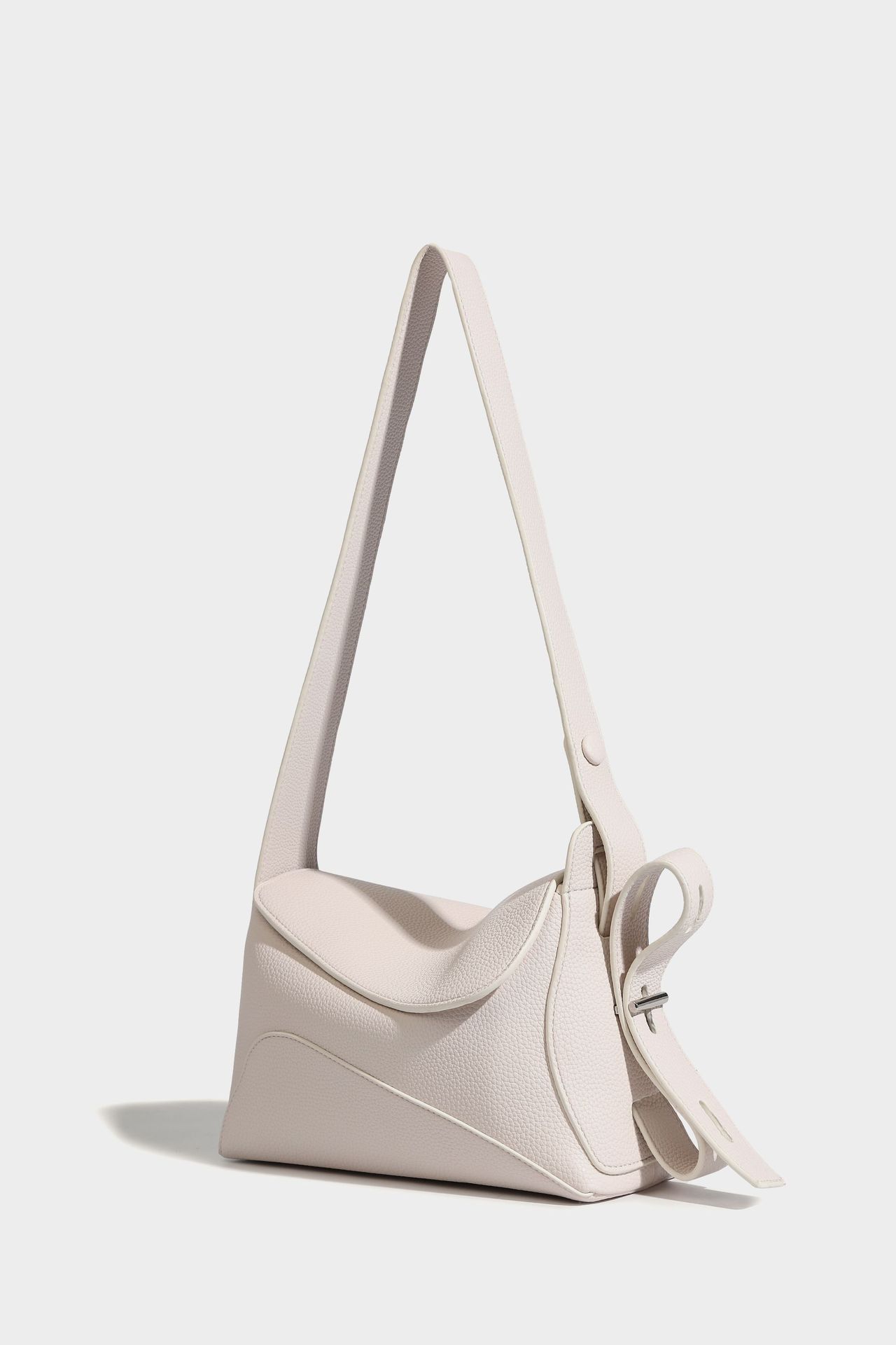 Minimalist cowhide leather tote bag on plain background