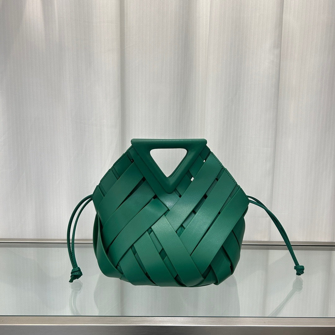 Close-up of weaving and buckle on leather crossbody bucket bag
