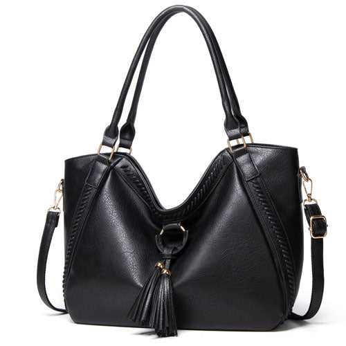 Black handbag with a tassel on a white background