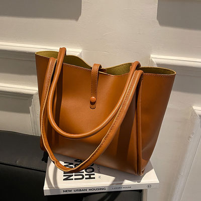 Flat lay of PU leather tote with matching inner pouch
